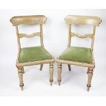 A set of four Regency bleached mahogany dining chairs, with scroll bar backs and upholstered seats,