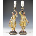 A pair of figural lamp bases, each gilt painted and modelled in typical eastern costume,