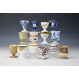 A collection of thirteen 19th and 20th century Wedgwood egg cups, all of a different design,