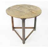 An 18th century oak cricket table, with three plank top, on triangular legs and stretchered base,