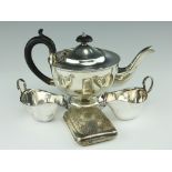 A silver teapot, Sheffield 1930, with a pair of silver sauce boats, Birmingham 1930,