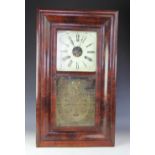 An American walnut wall clock, Roman numeral dial with paper label for E.