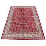 A Kashmir Tree of Life rug, worked with an allover design against a red ground,