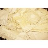 A selection of white linen textiles and fabrics to include broderie Anglaise, crochet,