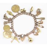 A 9ct yellow gold curb link bracelet hung with assorted charms,