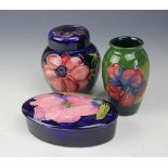 Three pieces of Moorcroft comprsing; a magnolia pattern oval box and cover 13.