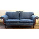 A modern three seater salon scroll end settee, with floral blue upholstery, on turned legs,