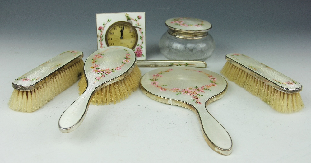 A George V silver and enamel seven piece dressing table set,