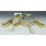 A George V silver and enamel seven piece dressing table set,
