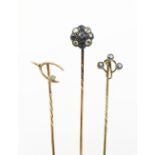 Three stick pins, to include; a sapphire and diamond cluster stick pin,