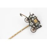 A stick pin in the form of a horse drawn carriage,