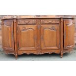 A late 19th century French Louis XV style oak sideboard, with two drawers and two cupboard doors,
