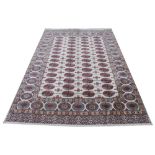 A Kerman brushed cotton carpet, decorated with an allover geometric design against an ivory ground,