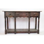 A George III style stained pine dresser base, with three drawers above a pot cupboad,