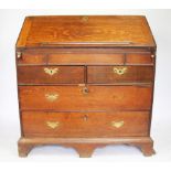 A George III oak bureau, with fall enclosing a fitted interior,