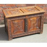 An 18th century style carved oak coffer, incorporating some early timbers, of small proportions,