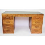 An Edwardian oak pedestal desk, with leather inset top above eight short drawers, on plinth base,