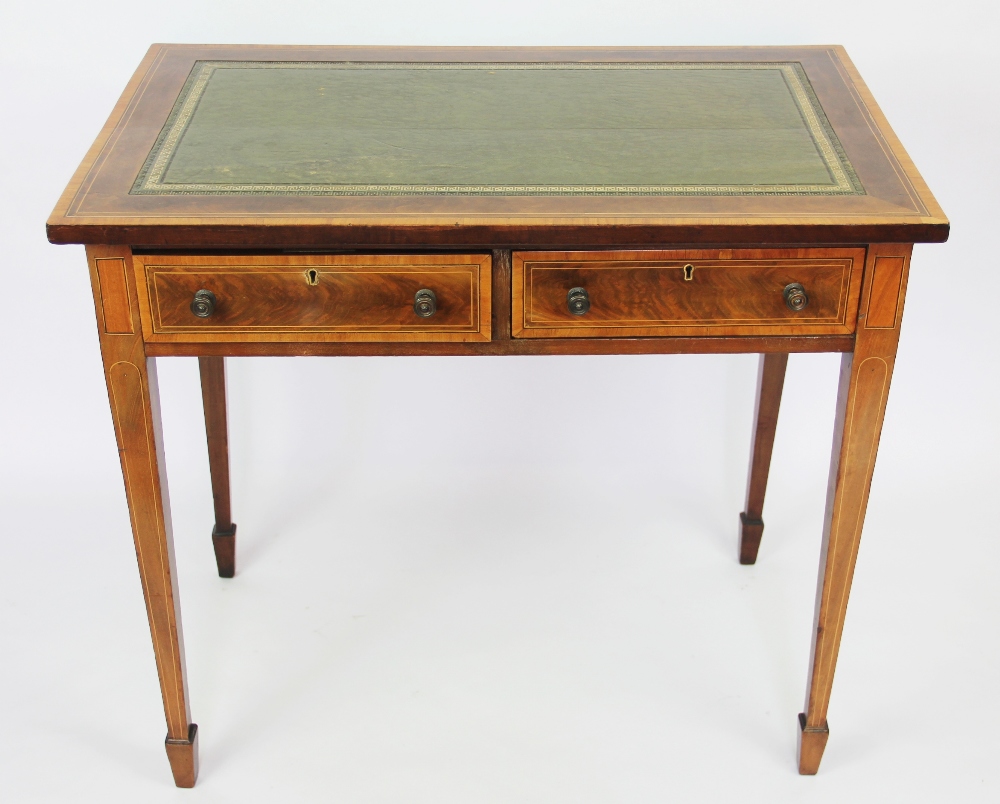 An Edwardian satinwood banded mahogany writing table, with leather inset top above two drawers,