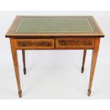 An Edwardian satinwood banded mahogany writing table, with leather inset top above two drawers,