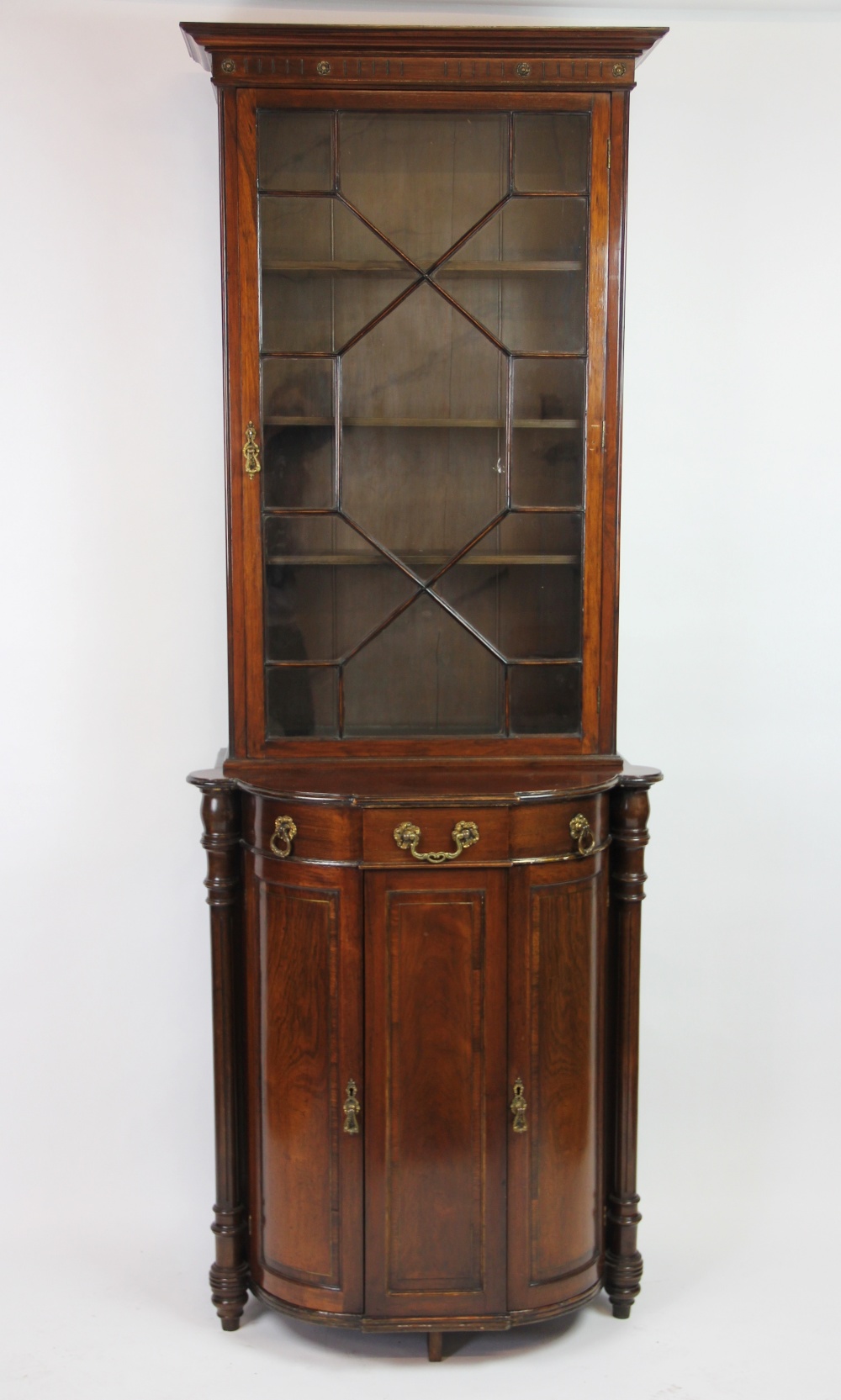 An early 20th century French rosewood display cabinet of slender proportions,