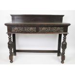 A Victorian carved oak buffet, of 17th century style, with raised back and two drawers,