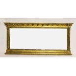A Regency gilt wood and gesso over mantel mirror, with fluted Corinthian pilasters,