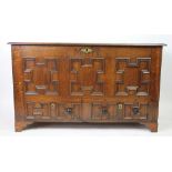 An 18th century oak mule chest, with fielded panel front and two drawers below, on bracket feet,