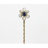 A sapphire and diamond cluster set stick pin,