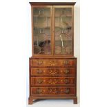 An Edwardian inlaid mahogany bookcase, in the manner of Edwards and Roberts of slender proportions,