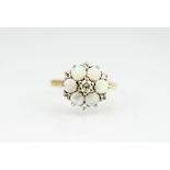 An opal and diamond set circular cluster ring,
