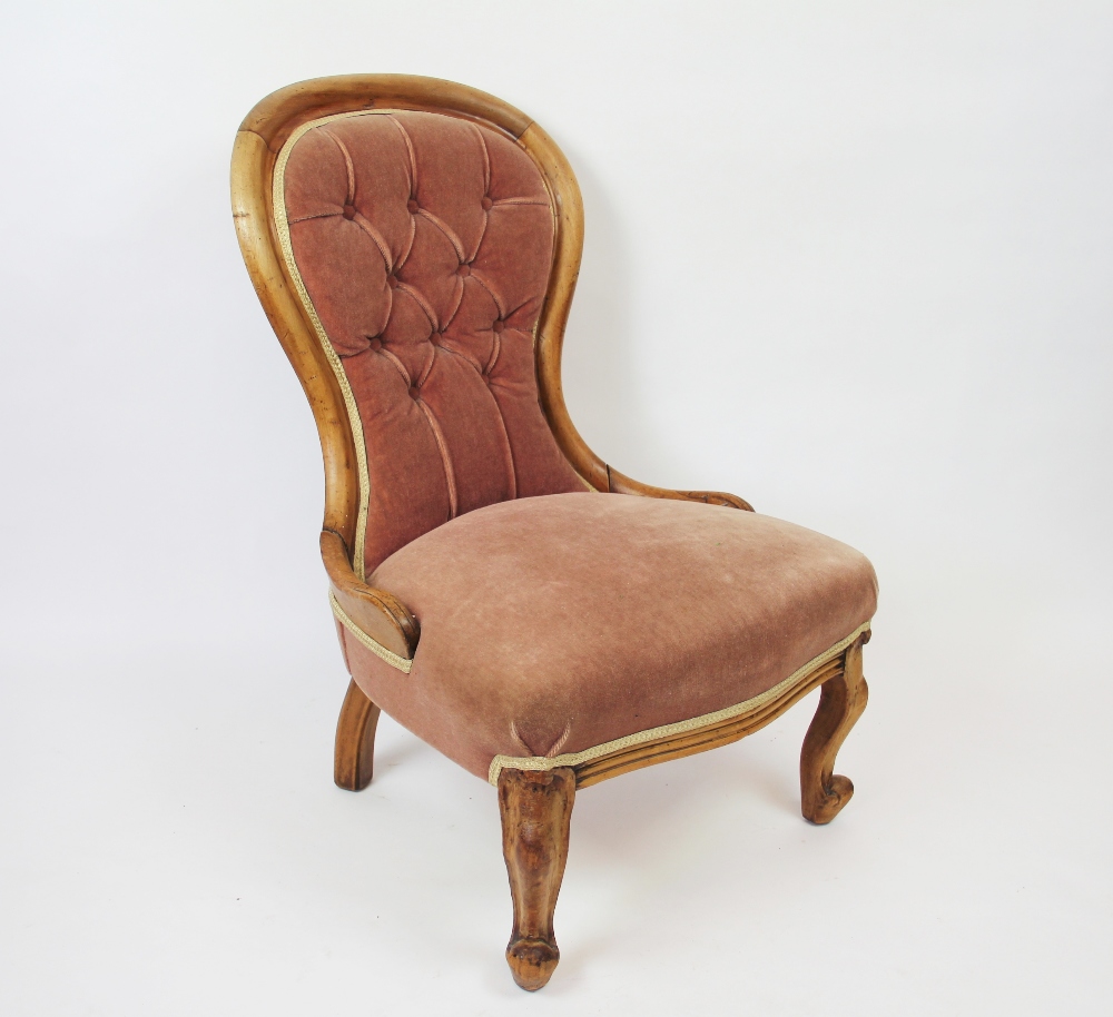 A Victorian walnut salon chair, on cabriole legs,