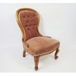 A Victorian walnut salon chair, on cabriole legs,