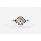 A four stone diamond ring, the four brilliant cut diamonds within unusual kite shaped setting,