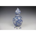 A Chinese pottery blue and white double gourd vase, decorated with prunus, 30cm,