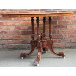 A Victorian inlaid walnut oval centre table, on carved and turned legs, fitted castors,