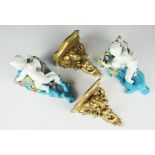 A pair of Victorian Moore pottery wall pockets, each modelled with cherubs and florally encrusted,