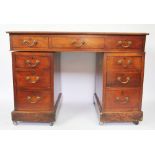 An Edwardian walnut pedestal desk,