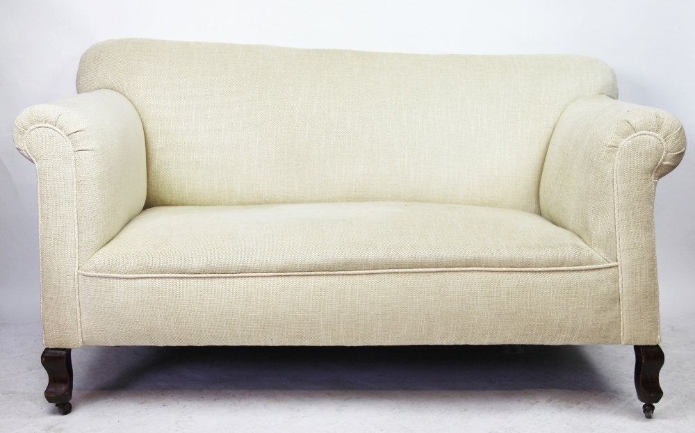 An Edwardian salon settee, with modern beige upholstery, on serpentine legs,