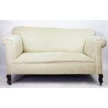 An Edwardian salon settee, with modern beige upholstery, on serpentine legs,