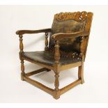 An early 20th century golden oak monks bench / seat, the pierced back with crown detailing,