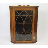 A George III oak hanging corner cabinet, with astragal glazed door,