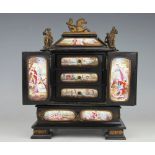 A 19th century Viennese enamel and ebonised miniature table cabinet, enclosing three drawers,