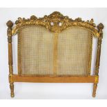 A carved gilt wood bed head,