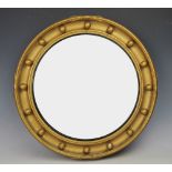 A Regency style gilt wood and gesso circular convex wall mirror,