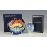 A Moorcroft Centenary pin dish, plate 1897-1997, decorated with a lily and dates,