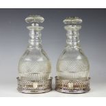 A pair of 19th century silver plated and pierced decanter coasters, with turned wood bases,