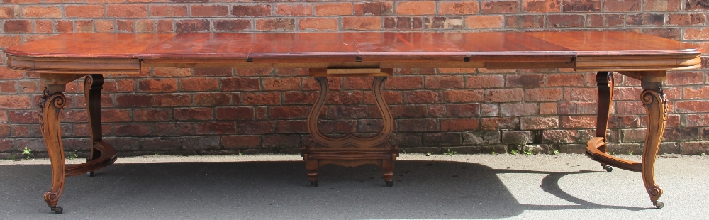 A late 19th century French carved walnut extending dining table,