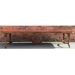 A late 19th century French carved walnut extending dining table,