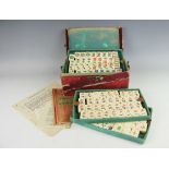 An early 20th century bone Mahjong set, within leather bound case enclosing four removable trays,