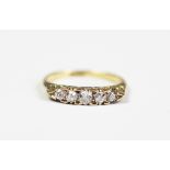 A five stone diamond ring, the five graduated old cut diamonds within boat shaped setting,